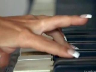 Gros seins blondie jouant abricot sur la piano
